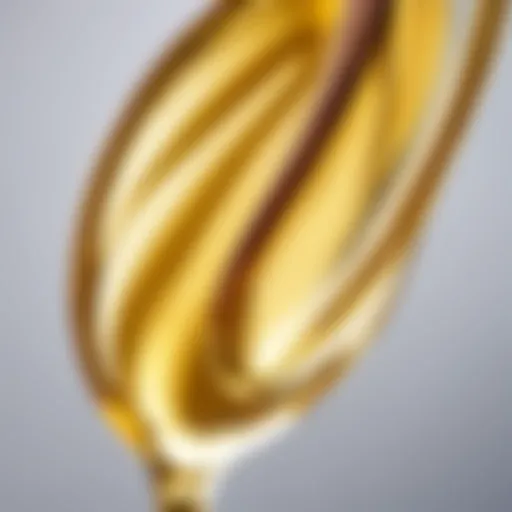 Close-up of almond oil droplet on hair strands