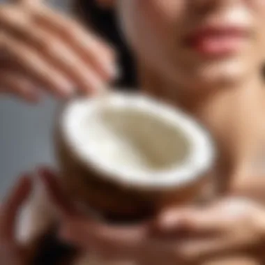 A hand applying coconut oil to hair ends