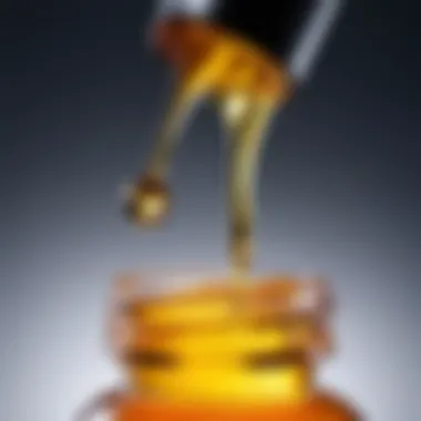 Close-up of a dropper dispensing oil