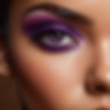 Close-up of a model showcasing eye makeup with purple tones on brown skin.