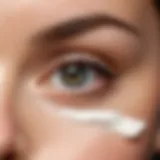 A close-up view of soothing eye cream application on the skin under the eyes.