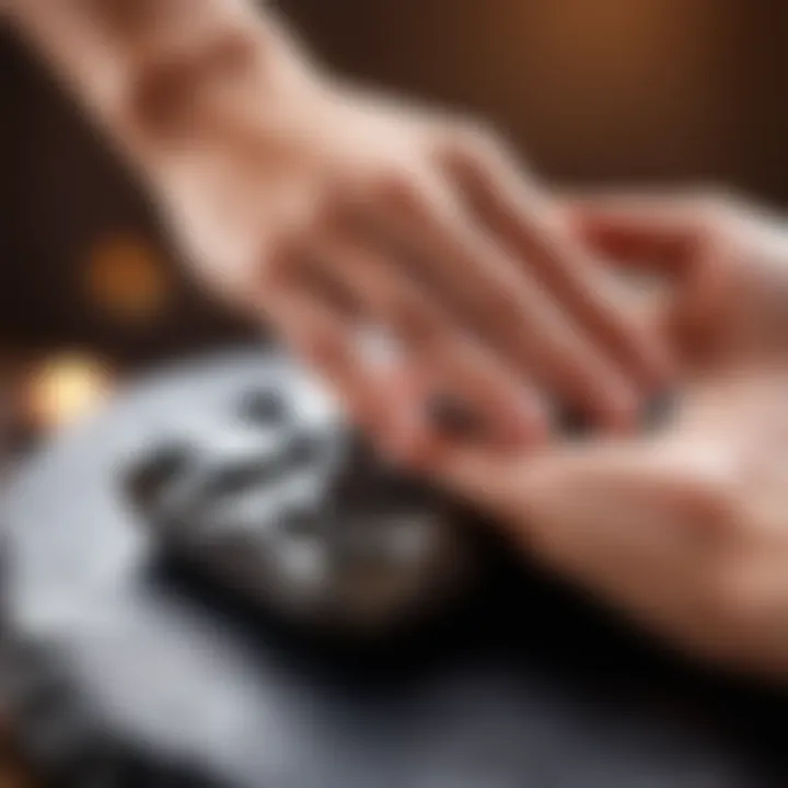 Close-up of a hand applying a hot stone during a massage session.