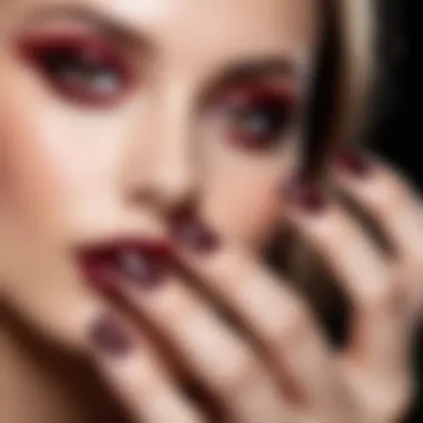 Glittering burgundy nail polish applied on a perfectly manicured nail.