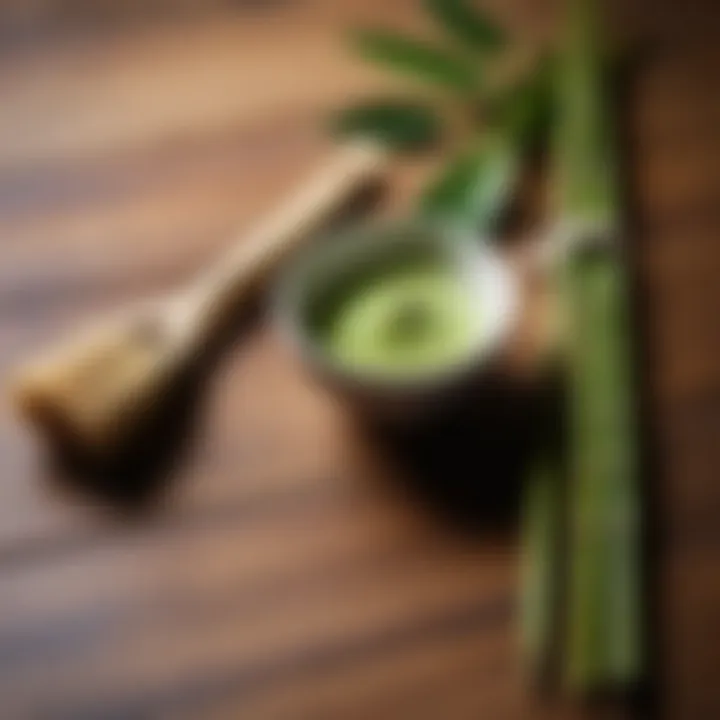 Close-up of matcha tea whisk and bamboo utensils on a wooden table