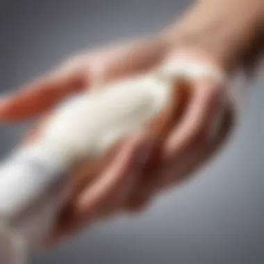 Close-up of a hand applying body lotion with care